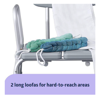 Two long, braided loofas in blue and green with handles rest on the Medline Bathe Safe and Easy Kit for Caregivers with Shower Transfer Bench. Text below reads: “2 long loofas for hard-to-reach areas.”.