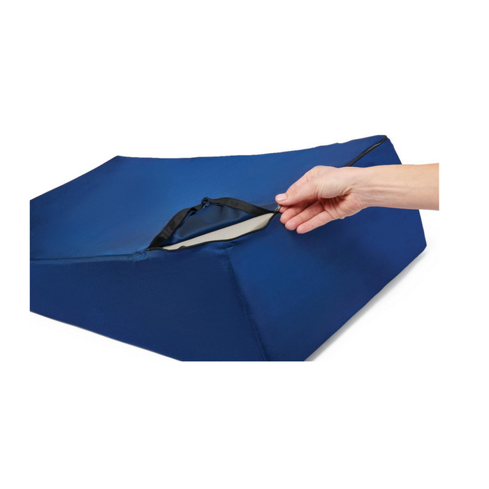 A hand unzips the cover of the Medline High-Density Foam Bed Wedge (24 x 20 x 8.5), revealing its inner layer. The versatile blue cushion is shown on a white background.