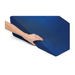 A hand presses into the Medline High-Density Foam Bed Wedge (24 x 20 x 8.5), showcasing its softness and flexibility on a white background. The dark blue, wedge-shaped cushion offers versatile elevation for multiple needs.