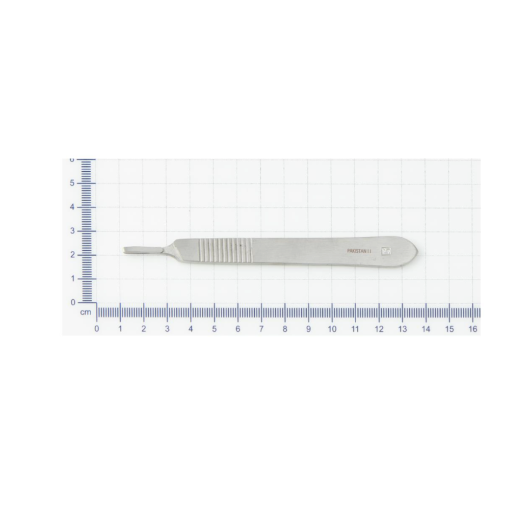 A Medline Floor Grade Scalpel Handle – #3 Disposable with a textured grip lies on graph paper with a blue centimeter scale, showing it's about 15 cm long.