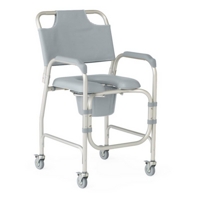 The Medline Drop-Arm Bedside Commode, with a light gray frame and padded armrests, features adjustable seat height for comfort. It includes four wheels for mobility and a removable commode bucket underneath.