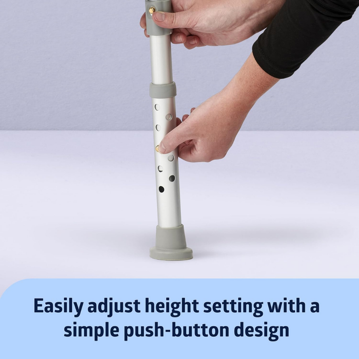 A user adjusts the Medline Bariatric Padded Bathtub Transfer Bench’s height with a push-button on the metal shaft. It features gray rubber tips and text below reads, Easily adjust height setting with a simple push-button design.