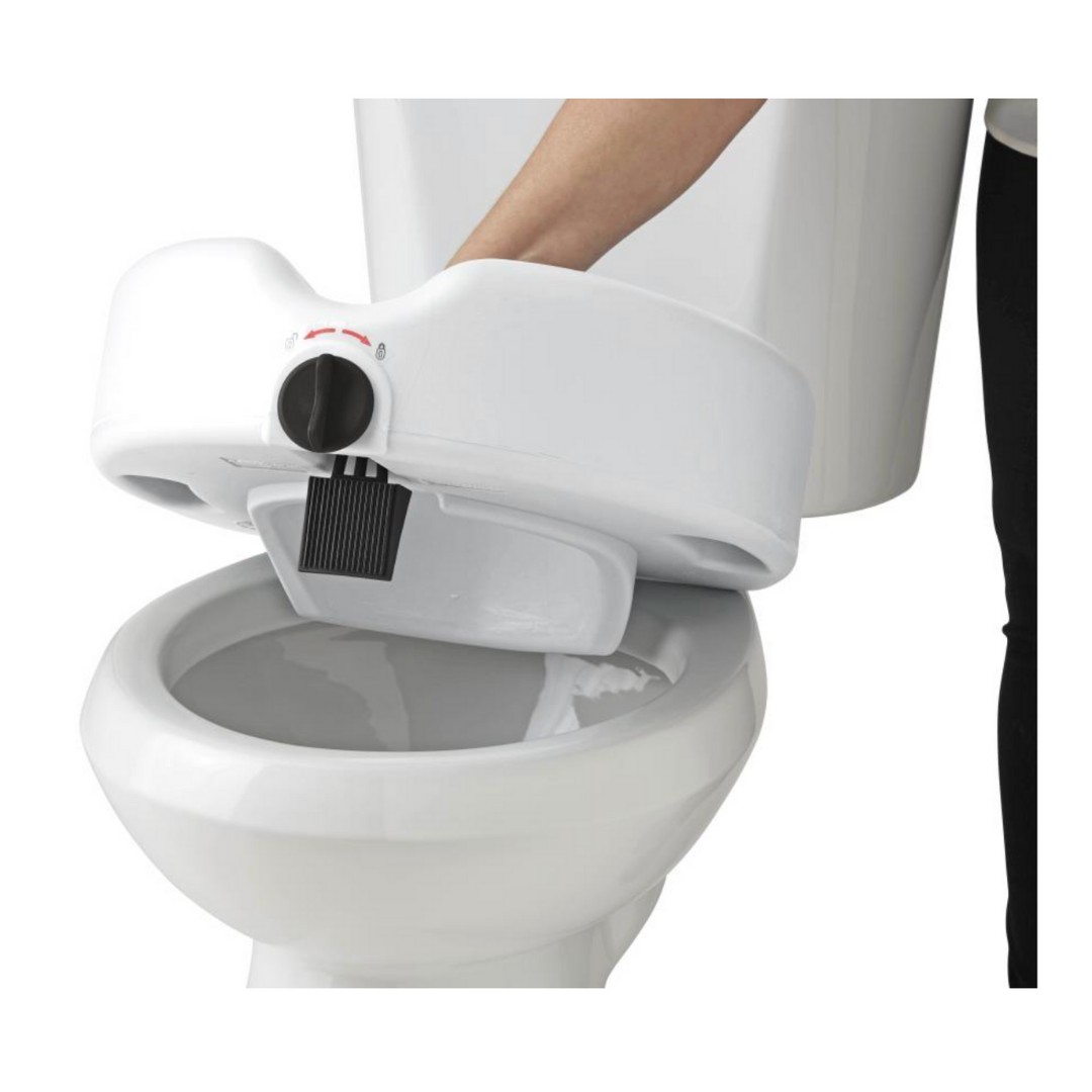 A person installs the Medline 5 Raised Locking Toilet Seat with Microban Treatment onto a toilet bowl, reaching through the top opening to improve bath safety.