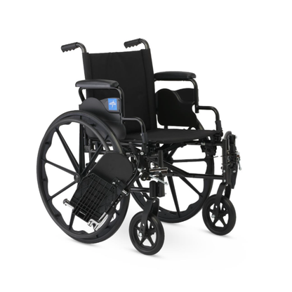 The Medline Guardian K4 Wheelchair with Desk-Length Arms is black with large rear wheels, small front wheels, padded armrests, footrests, and a mesh storage pouch under the seat. It is shown against a plain white background.