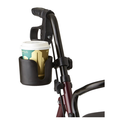 A burgundy walker with a Medline Cup and Cane Holder Combo Pack, including a black drink holder attached to the handle with a disposable coffee cup and white lid, illustrating practical rollator accessories.