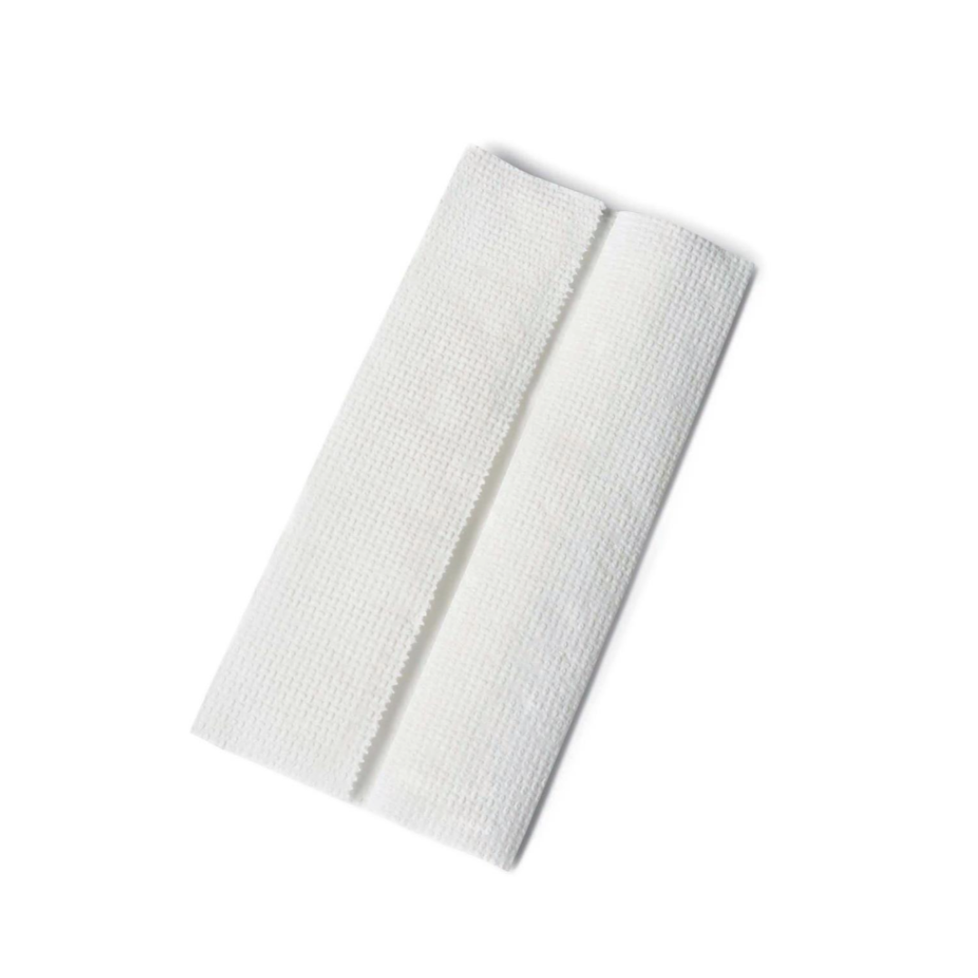A single, folded, white gauze pad with a textured surface sits on a plain white background, evoking the clean and hygienic feel offered by Medline Multifold Paper Towels.