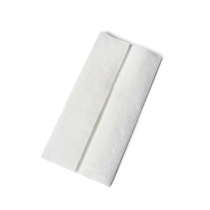 A single, folded, white gauze pad with a textured surface sits on a plain white background, evoking the clean and hygienic feel offered by Medline Multifold Paper Towels.