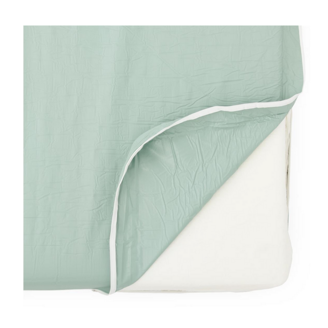 A pastel green, crinkled fitted sheet with a white elastic edge is partially pulled back to reveal the Medline Premium Foam Homecare Mattress, sized 36” x 80” x 6”, offering extra protection and comfort for your bed.