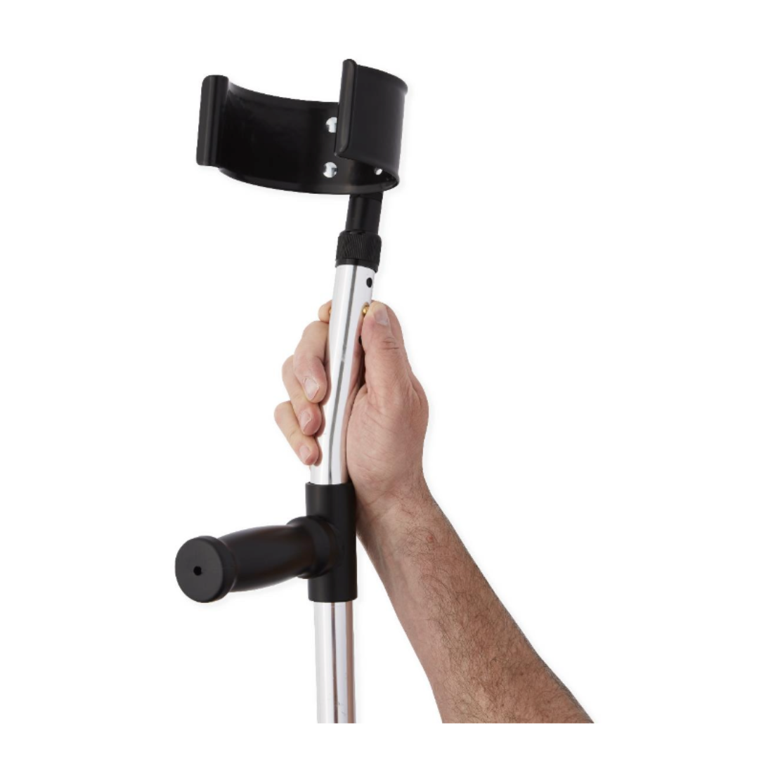 A hand adjusts the height of a Medline Premium Forearm Crutch with a silver finish, black handle, and cuff against a white background.