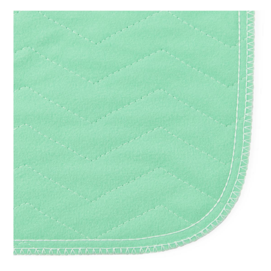 Close-up of Medline Quick Dry Poly Laminated Reusable Underpads (34 x 36) featuring light green quilted fabric, zigzag stitching, rounded edges, and a breathable polyurethane film for added comfort.