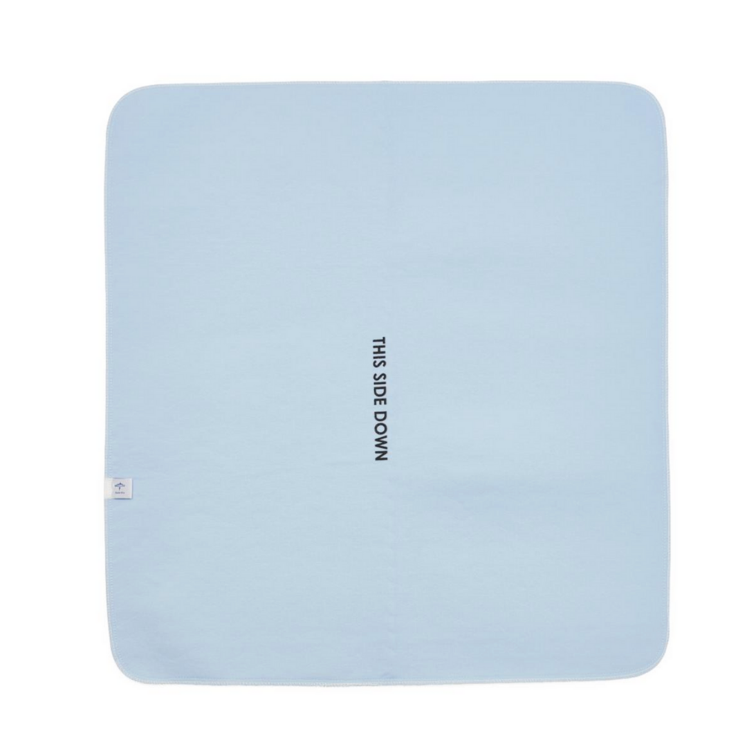 The Medline Quick Dry Poly Laminated Reusable Underpad, 34 x 36, is light blue, rectangular, with THIS SIDE DOWN in black at the center and a small white tag near one corner. Made from an advanced fiber blend.