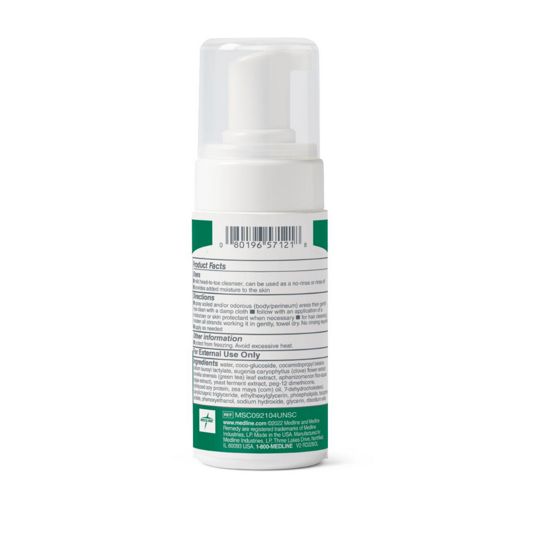 The Medline Remedy Clinical No-Rinse Foam Cleanser - Body Wash & Shampoo comes in a white bottle with a pump, green label, clear cap, and features usage instructions, ingredients, and a barcode on the back. The hypoallergenic formula requires no rinsing.