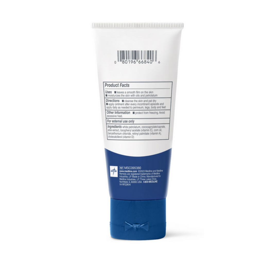 A blue and white Medline Remedy Essentials Moisturizing Ointment tube is shown from the back, featuring a barcode, product facts, directions, ingredients, and a medical cross symbol. Its blue cap faces downward on this fast-absorbing moisturizer.