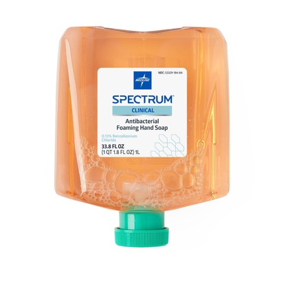 A large rectangular bottle of Medline Spectrum Antibacterial Foaming Hand Soap with a green cap, orange-tinted liquid, and visible bubbles inside offers germ protection, displayed against a white background.