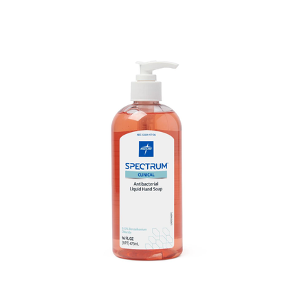 A clear pump bottle of Medline Spectrum Antibacterial Liquid Hand Soap, filled with vibrant orange soap and featuring a white label, stands upright against a plain white background.