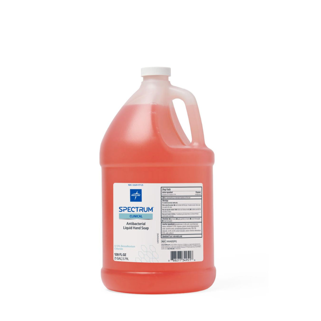 A large, clear plastic gallon jug of Medline Spectrum Antibacterial Liquid Hand Soap with a white cap and handle, featuring orange soap and a white-and-blue label displaying product information.