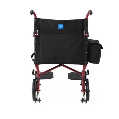 Rear view of a Medline Steel Transport Chair with Wide 19" Seat, featuring a red frame, black seat and backrest, small wheels, and a side pocket on the right armrest—ideal for convenient travel.