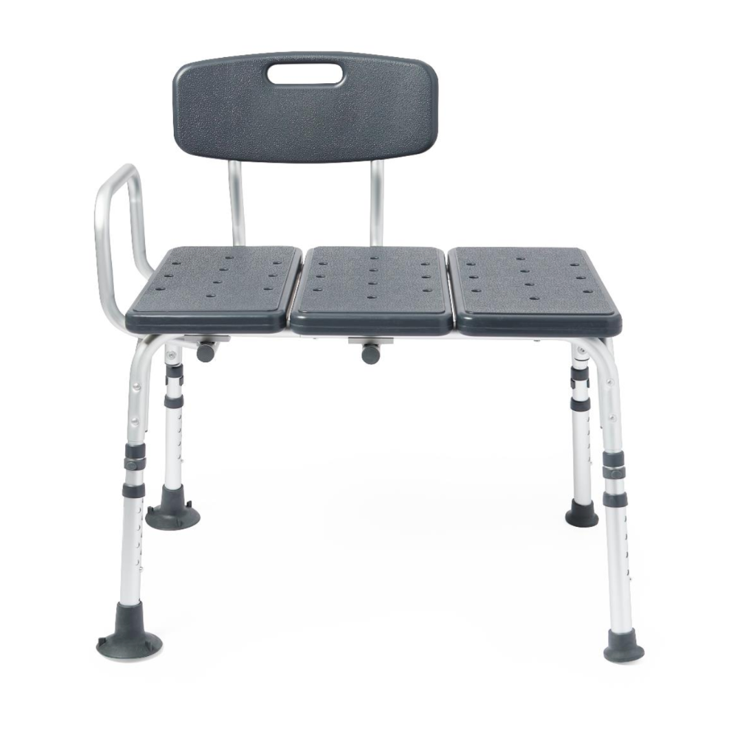 The Medline Tub Transfer Bench features a reversible backrest, armrest, and three perforated seats for drainage. It has rust-resistant aluminum adjustable legs with rubber tips for stability and a convenient handle on the backrest for easy portability.
