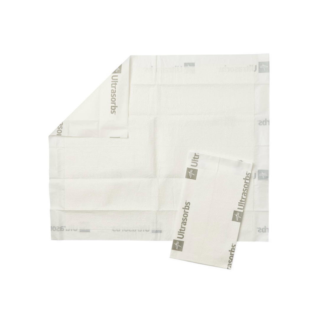Two Medline Ultrasorbs Premium Underpads - Superabsorbent are shown, one folded and one unfolded, both with gray Ultrasorbs branding on the edges. These air-permeable pads appear on a plain white background.