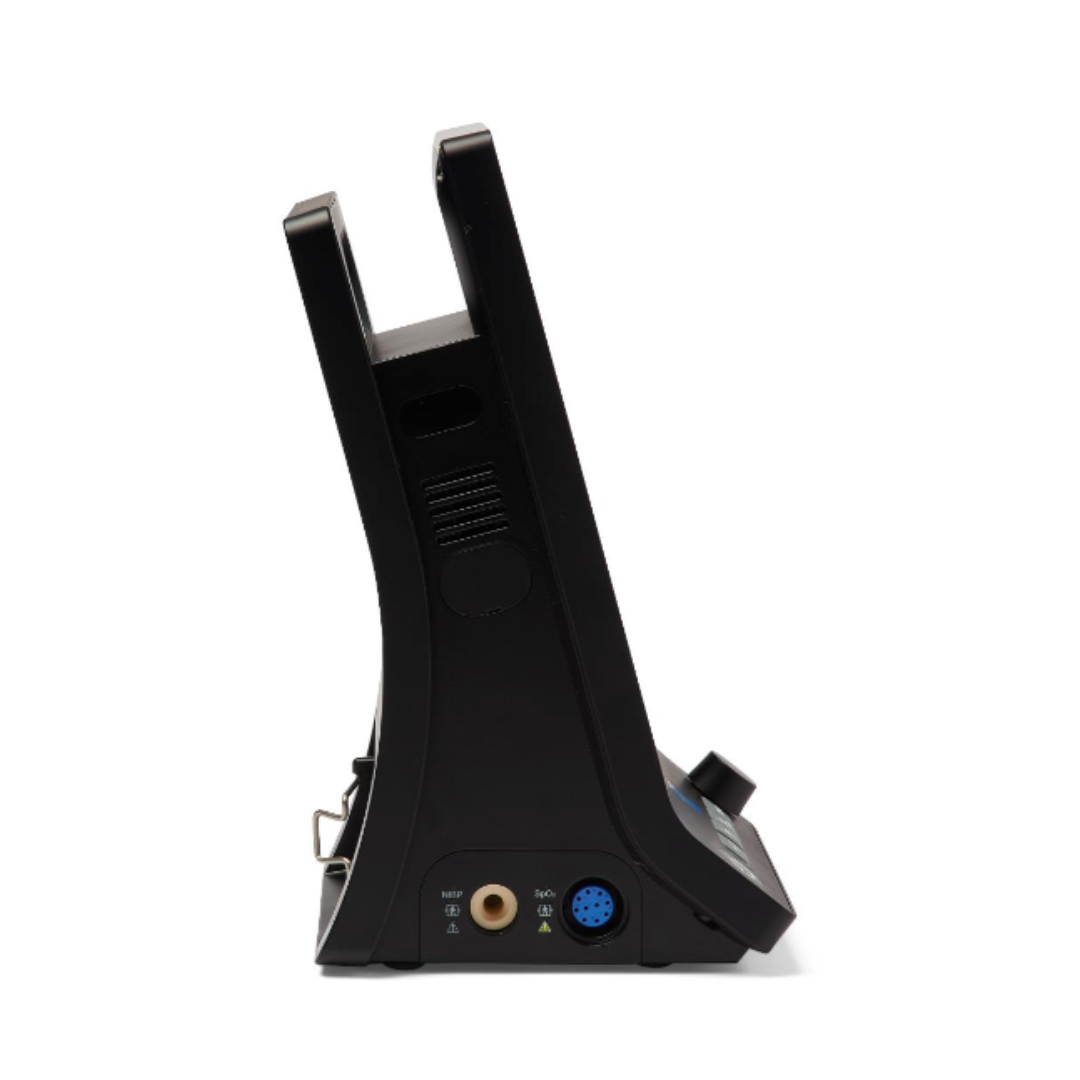 A side view of a black Medline Vital Signs Monitor with Blood Pressure and SpO2, showing ports at the base—including a round blue port and an audio jack. The device is upright and angled, with buttons and vents visible.