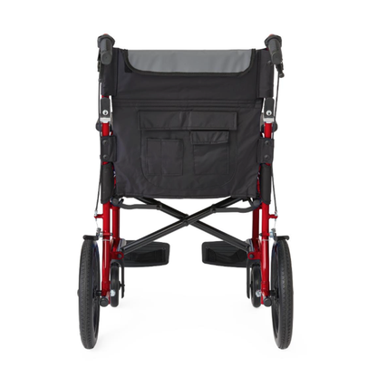 A rear view of the Medline Zero G Ultralite Transport Chair in red, featuring a lightweight aluminum frame, large black wheels, and a black seat back with pockets and storage compartments.