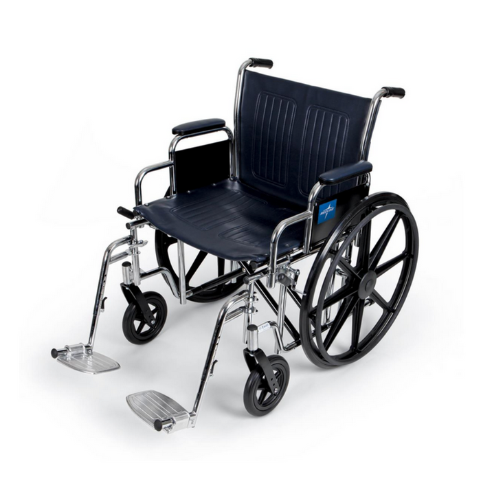 The Medline Bariatric Extra-Wide Wheelchair features a black, sturdy carbon steel frame with large rear wheels and small front casters. It includes footrests and armrests, with a cushioned seat and backrest in navy vinyl upholstery for comfort, set against a plain white background.