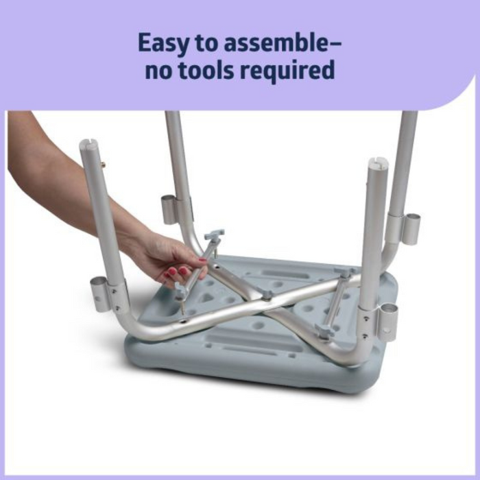 A hand assembles the Medline Knockdown Portable Shower Chair with Padded Armrests on a light blue seat. Text above reads, Easy to assemble—no tools required. The chair features four legs with rubber tips and a durable, height-adjustable seat.