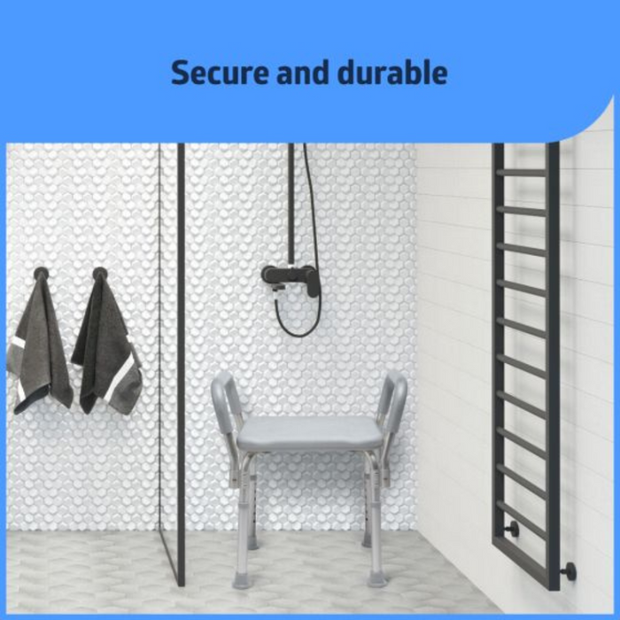 In a modern bathroom, a textured white wall features a walk-in shower and the Medline Knockdown Portable Shower Chair with Padded Armrests. Two dark towels hang on the left, and a sleek black vertical towel rack is on the right. Text above reads Secure and durable.