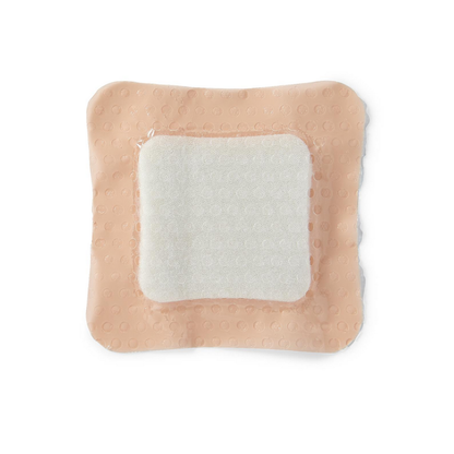 The Medline Optifoam Gentle SA Silicone-Faced Foam Wound Dressing is a square adhesive bandage with a raised white absorbent pad and peach-colored, textured border featuring gentle silicone adhesive, shown on a white background.