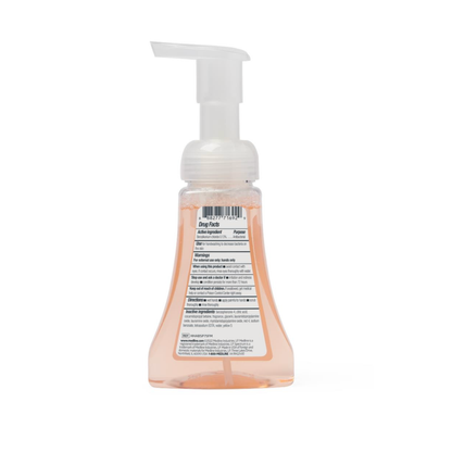 A clear pump bottle of Medline Spectrum Antibacterial Foaming Hand Soap, peach-colored liquid visible from the back, with a white label containing product details and a white foaming pump top for effective germ protection.