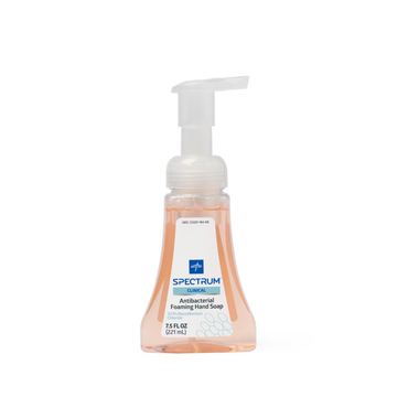 A clear plastic pump bottle of Medline Spectrum Antibacterial Foaming Hand Soap with light orange liquid, 7.5 fl oz (221 mL), and a blue and white label that highlights its effective germ protection.