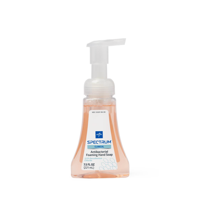 A clear plastic pump bottle of Medline Spectrum Antibacterial Foaming Hand Soap with light orange liquid, 7.5 fl oz (221 mL), and a blue and white label that highlights its effective germ protection.