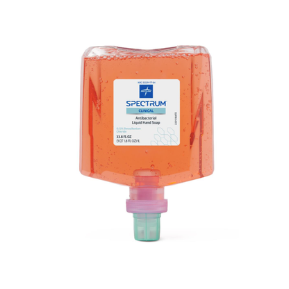 A clear plastic refill container of orange Medline Spectrum Antibacterial Liquid Hand Soap, labeled Spectrum Clinical, with a light purple cap at the bottom.