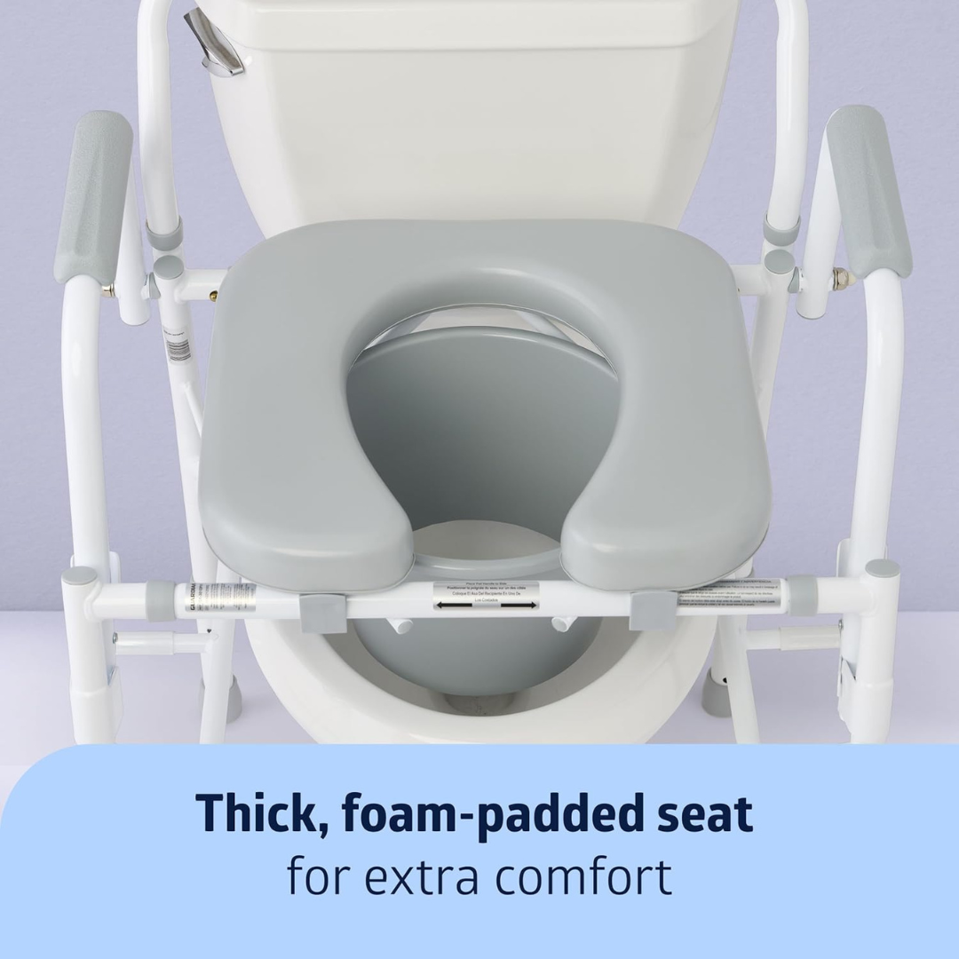 A gray, thick, foam-padded seat is attached to the Medline Steel Drop-Arm Bedside Commode with armrests, positioned over a toilet. Text at the bottom reads: Thick, foam-padded seat for extra comfort.