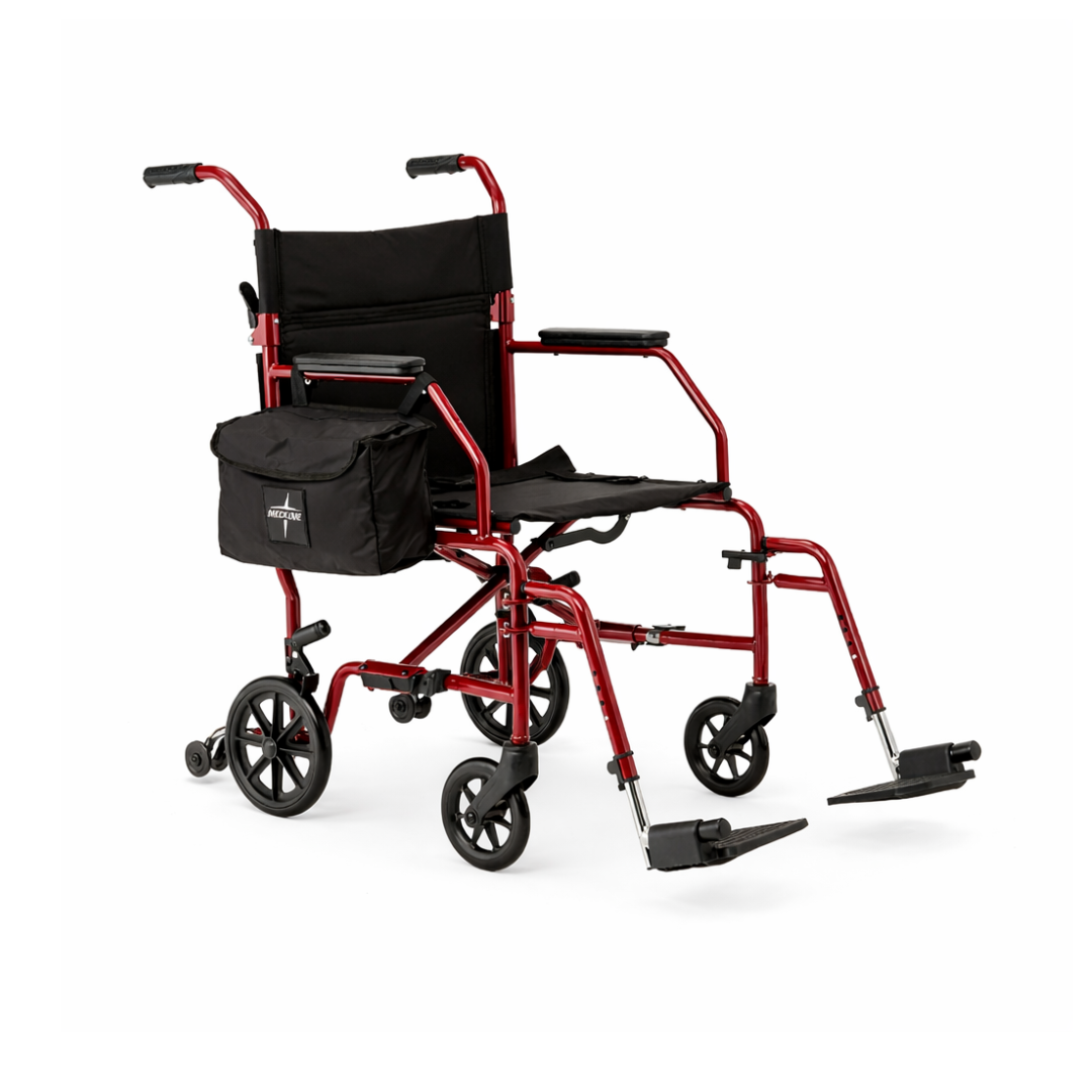The Medline Steel Transport Chair with Wide 19" Seat is a lightweight red mobility aid with black seat, armrests, detachable side bag, four small wheels, and foldable footrests—ideal for easy and convenient transport.