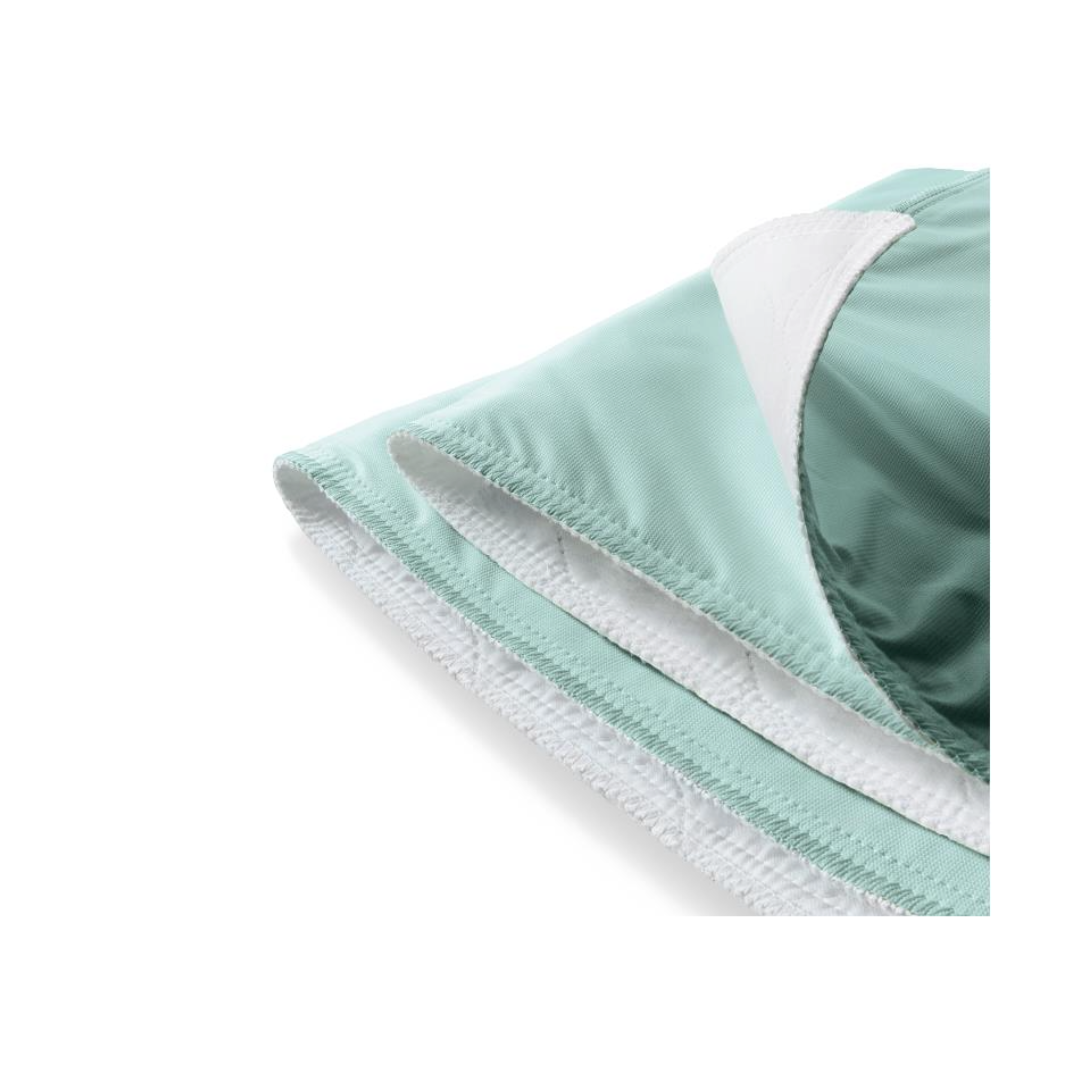 Close-up of the Medline Washable Underpads (30" x 34") in light green and white, highlighting padded, smooth fabric with stitching and an interior pocket—features that ensure comfort and durability in these reusable underpads.