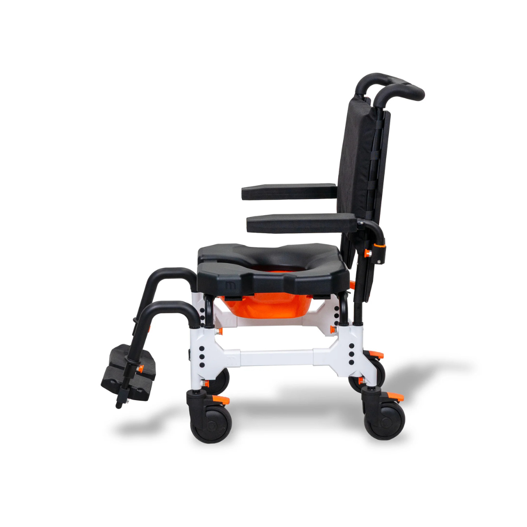 Side view of a white MetaPal® M1-AP Attendant-Propelled Shower Commode Chair with a black seat, backrest, armrests, and footrests, featuring orange accents and four locking casters.