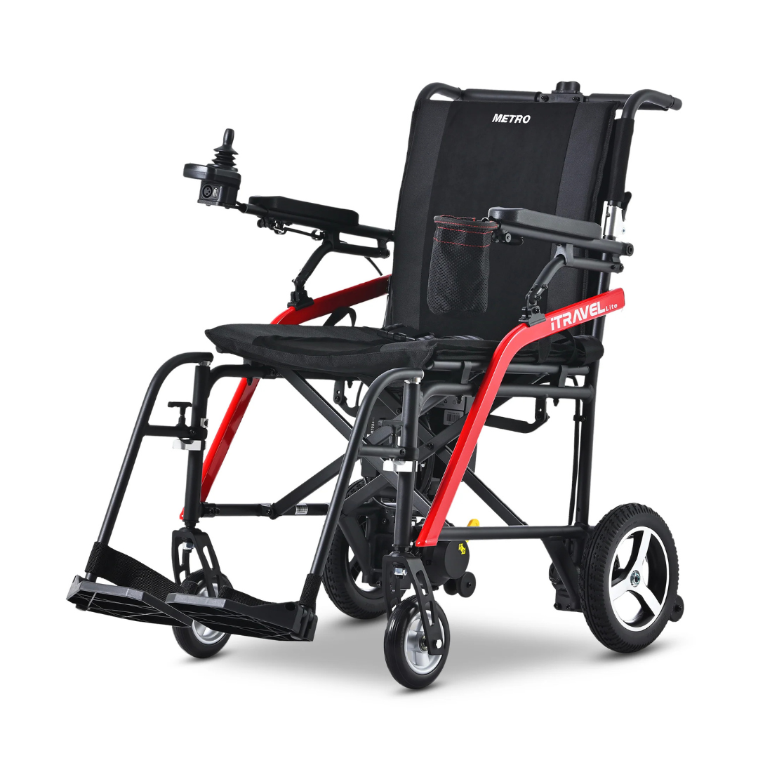 The Metro Mobility iTravel Lite Portable Powerchair is a black and red, airplane-friendly electric wheelchair with a joystick on the armrest, foldable footrests, mesh seat pocket, and large rear wheels—perfect for travel or mobility assistance.