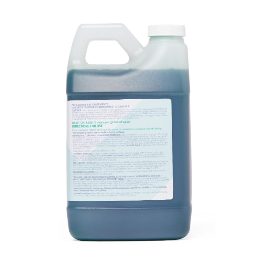 A large translucent plastic jug with handle and screw cap holds dark blue liquid. The front label details Medline Micro-Kill NQ10 Disinfectant – 64 oz Bottles, featuring instructions and product info in blue and black text.