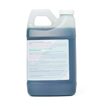 A large translucent plastic jug with handle and screw cap holds dark blue liquid. The front label details Medline Micro-Kill NQ10 Disinfectant – 64 oz Bottles, featuring instructions and product info in blue and black text.