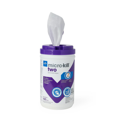A container of Micro-Kill Two Disinfectant Wipes with a purple lid and a white wipe being pulled out; the label highlights its hard surface cleaning power and antibacterial and antiviral protection.