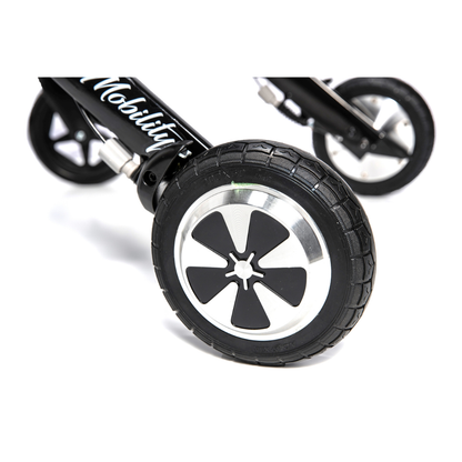 Close-up of two black and silver wheels with black tires attached to the Miracle Mobility Portable 4N1 Walker Wheelchair Combo, featuring "Mobility" in white on a black frame.