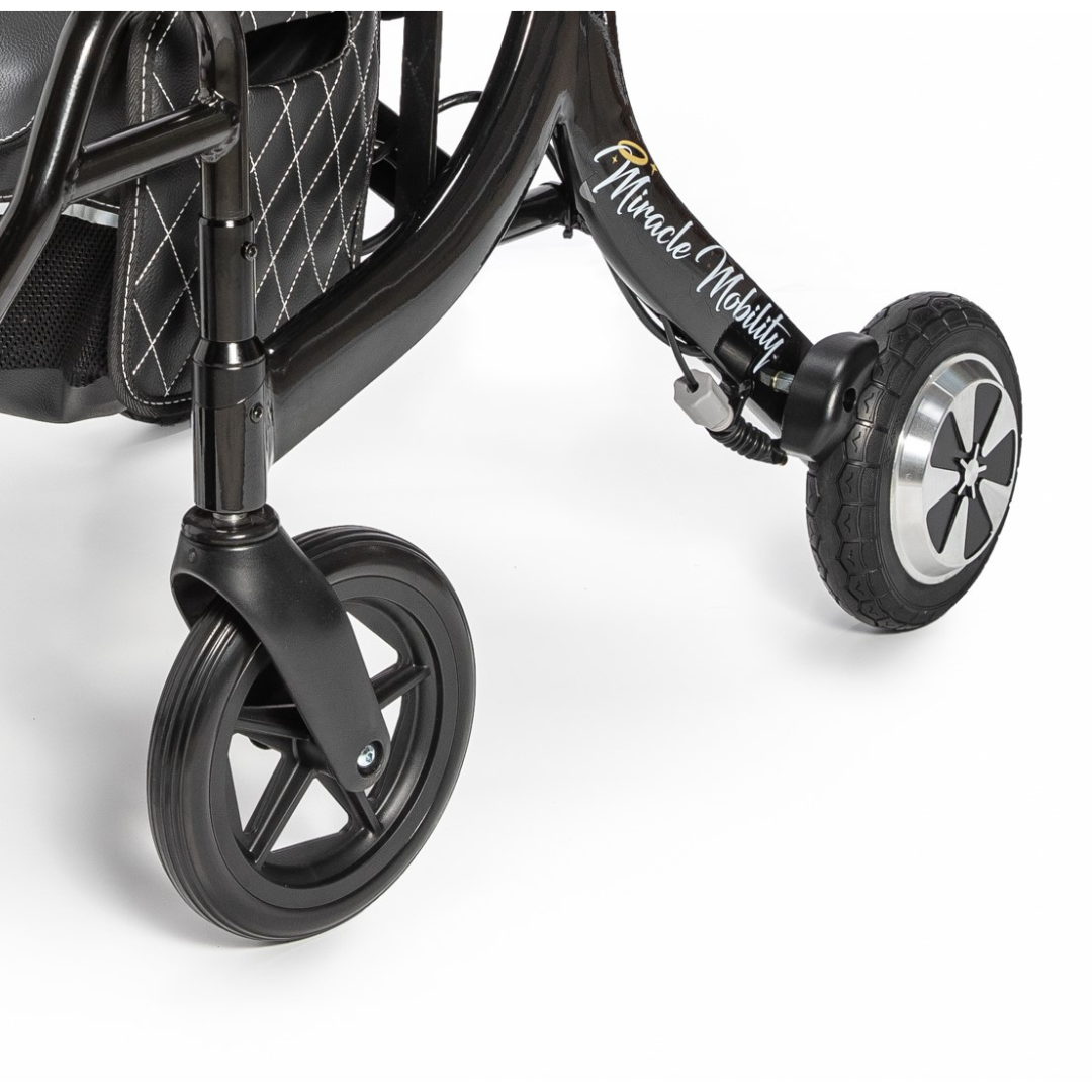 Close-up of the front wheels and lower frame of a black Miracle Mobility Portable 4N1 Walker Wheelchair Combo, with "Miracle Mobility" in script on the frame, set against a plain white background.