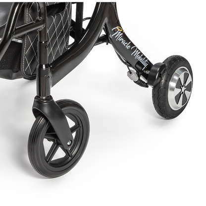 Close-up of the front wheels and lower frame of a black Miracle Mobility Portable 4N1 Walker Wheelchair Combo, with "Miracle Mobility" in script on the frame, set against a plain white background.