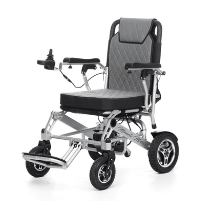 The Miracle Mobility 6000 Plus Portable Electric Wheelchair is lightweight, foldable, and features a cushioned seat and backrest, armrests, left-arm joystick control, four sturdy wheels, and a silver frame with black and gray accents.