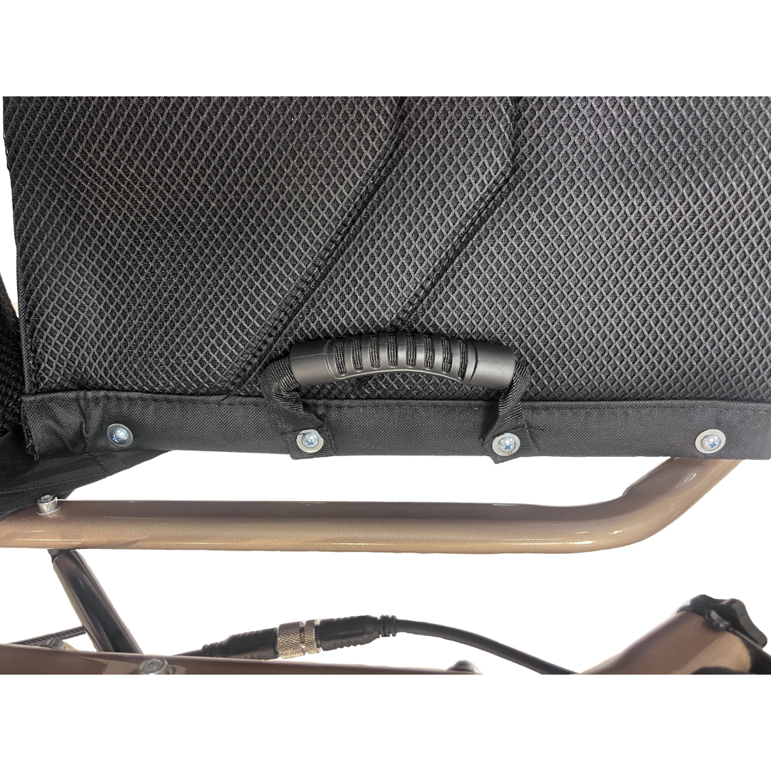 Close-up of the Miracle Mobility Falcon 5000 Lightweight Powerchair’s black mesh seat with a textured plastic handle, mounted on its metallic frame. A cable and bronze-colored support bar are visible underneath.