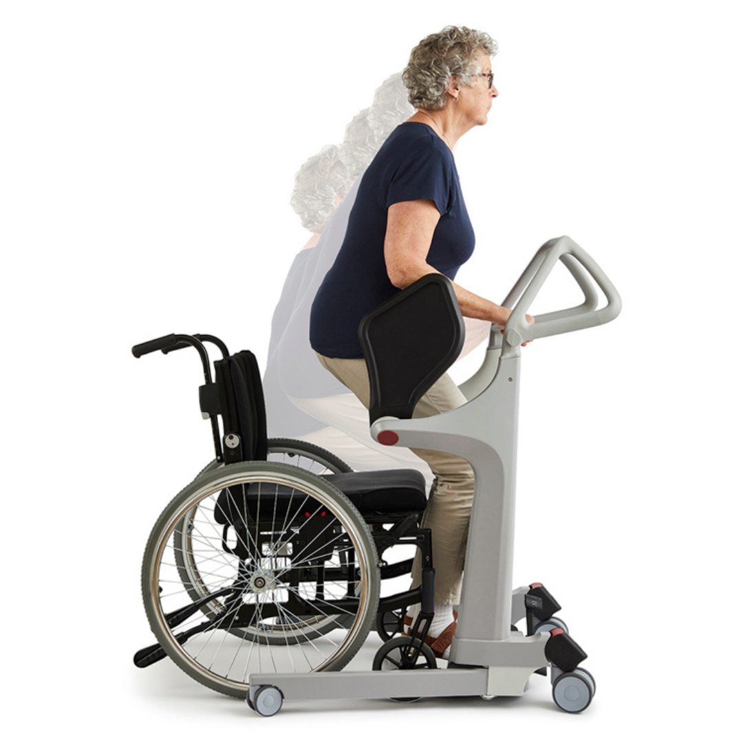 An older woman uses the Molift Transfer Pro – Innovative Sit-To-Stand Patient Lift to rise from her wheelchair. The device supports her as she transitions from sitting to standing, emphasizing mobility assistance.