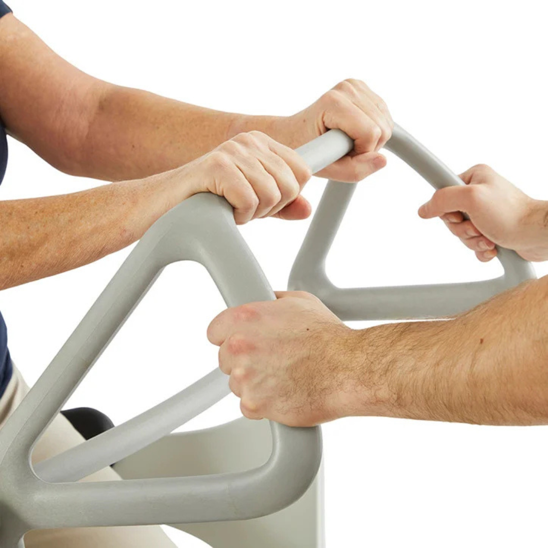 Two people grip the handles of the Molift Transfer Pro - Innovative Sit-To-Stand Patient Lift, finished in gray, against a plain white background, with only their hands and part of their arms visible.
