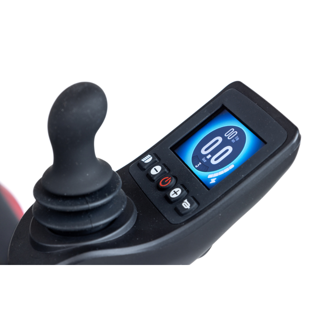 Close-up of the Monarch Flyer Ultra-Lite Carbon Powerchair joystick control panel, with a digital display showing speed, battery level, various control buttons, and key specs.