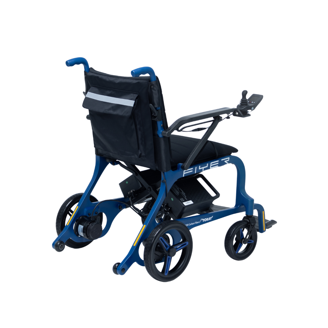 The Monarch Flyer Ultra-Lite Carbon Powerchair, a modern blue electric wheelchair with black seat, large rear wheels, small front wheels, armrest control panel, and rear storage pouch is shown against a white background. Specs and warranty details available.